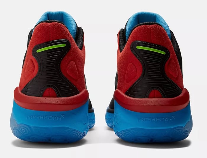 Rear view of red and blue New Balance shoes.